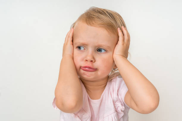istock Little baby with sad expression in face 1074829306