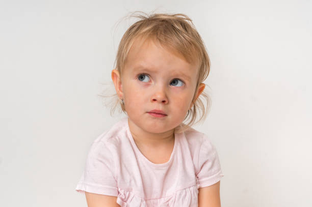 istock Little baby with sad expression in face 1074829370