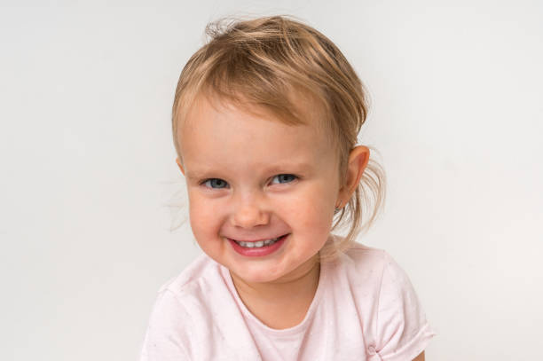 istock Beautiful smiling baby on isolated background 1074829594