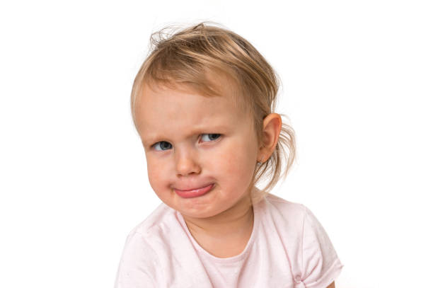 istock Little baby with sad expression in face 1074829980