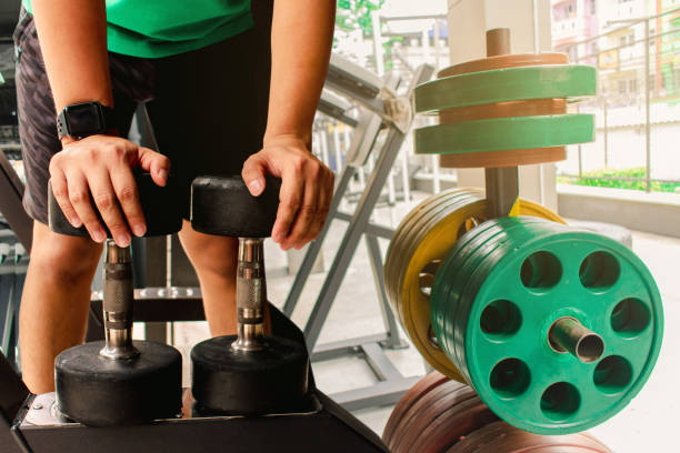 istock Asian man Bodybuilder with dumbbell weights power handsome athletic exercises.Metaphor Fitness and workout concept exercise Health lifestyle muscle body with take care of your health 1074829998
