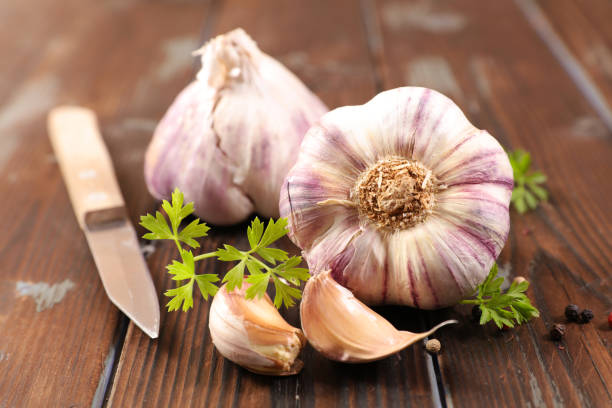 istock garlic on wood background 1074834562