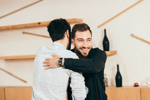 istock friends hugging while greeting each other in cafe 1074835866