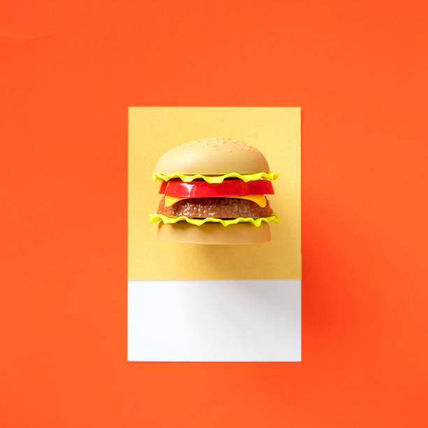Creative layout of big burger made of colorful gummy candies against red brick wall background. Minimal food concept. Tasty jelly sweets composition. Gummy candies aesthetic.