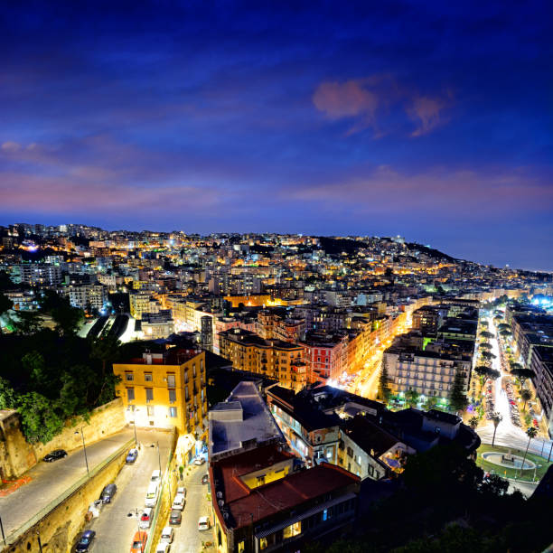 View of the illuminated streets of Naples city at night, Italy. Composite photo