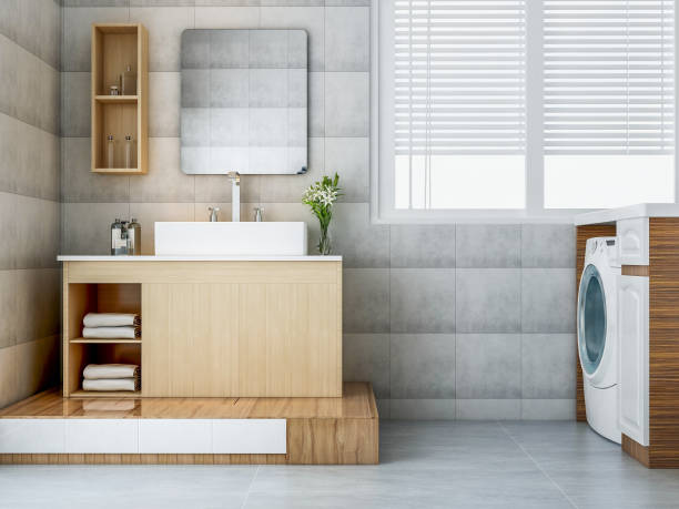 istock Modern spacious bathroom with sink and washing machine next to it 1074837464