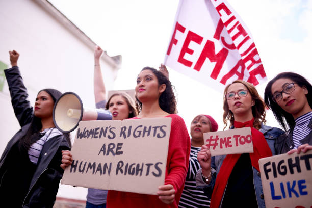 We have something to say, our voices will be heard Cropped shot of a woman holding up a poster that reads "Women's rights are human rights" while protesting with other women in the city me too social movement stock pictures, royalty-free photos & images