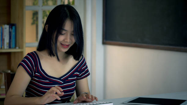 istock Young Asian Teenage girl using on a holographic computer terminal 1074846132
