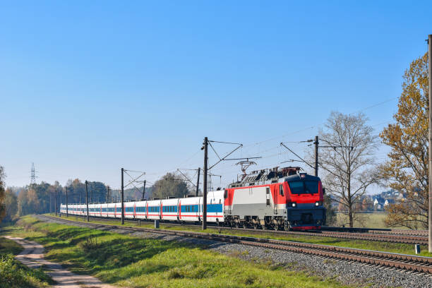 istock Express train cars traveling by rail among trees 1074846368
