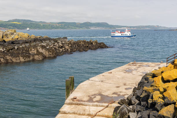 istock Launch ship appoaching Inchcolm Island with medieval abbey near Edinburgh 1074852858