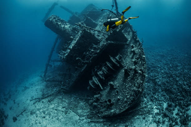 istock Yellow suited scuba diver exploring a shipwreck under the Red Sea 1074852916