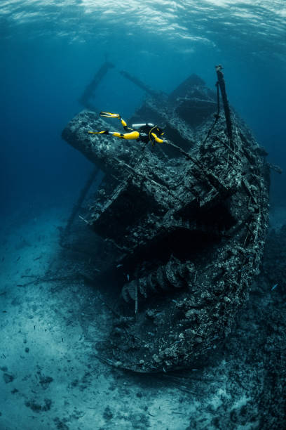 istock Scuba diver exploring a large shipwreck under the Red Sea 1074854336