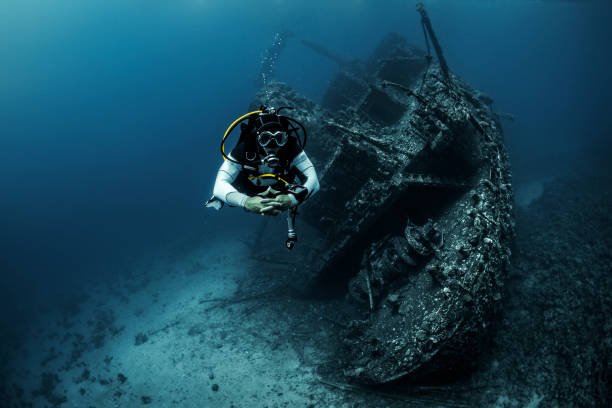 istock Scuba diver diving next to a shipwreck under the Red Sea 1074855096
