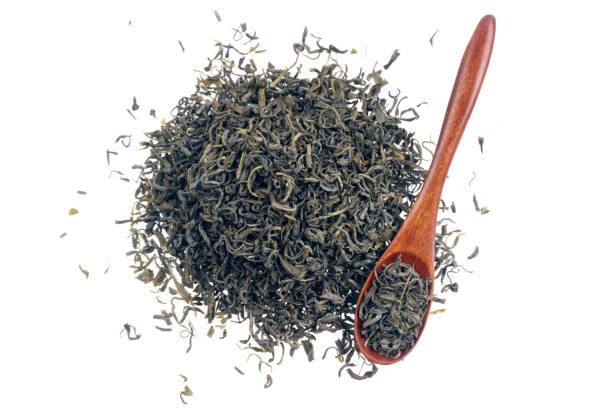istock Heap of dry green tea isolated on white background 1074857324