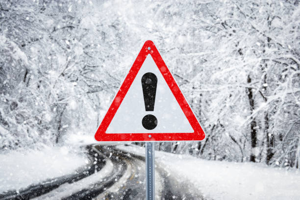 istock Warning traffic sign on a ice road 1074857600