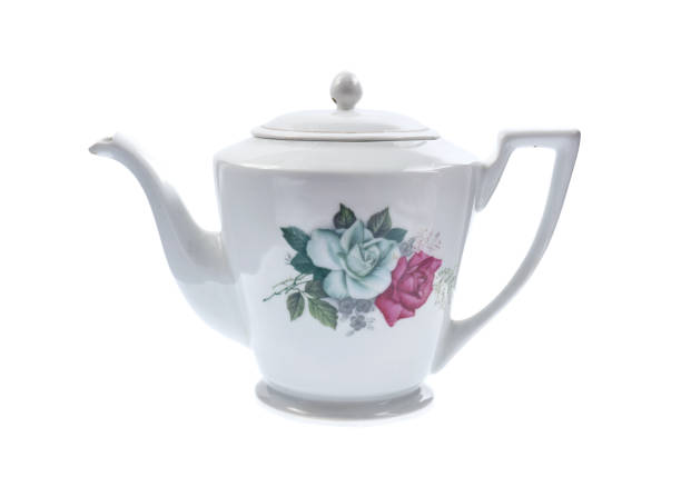 istock teapot on a white background Dark-red enameled pottery teapot on a white background 1074859834