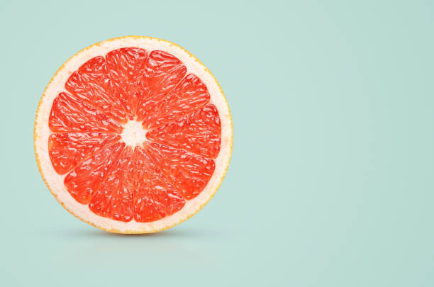 istock Perfect red grapefruit slice on pastel green 1074862062