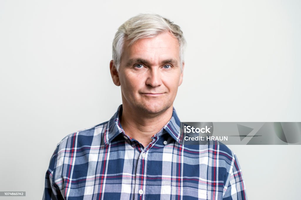 Portrait of confident mature businessman Portrait of confident mature businessman. Close-up of successful male professional is on white background. He is wearing plaid shirt. Men Stock Photo