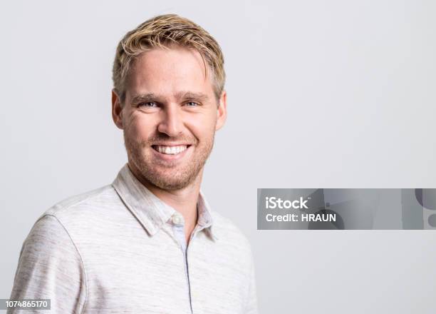 Portrait Of Smiling Young Man Stock Photo - Download Image Now - Blond Hair, Men, Males