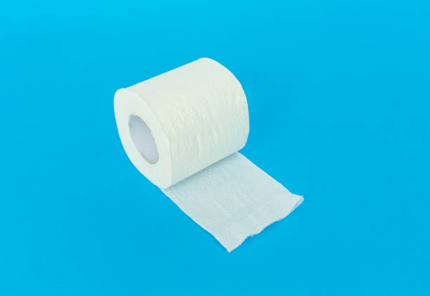 istock toilet paper on blue background. 1074869588
