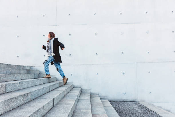 istock Woman running up steps in urban setting 1074874854