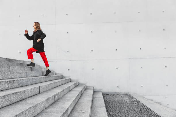 istock Woman running up steps in urban setting 1074874910