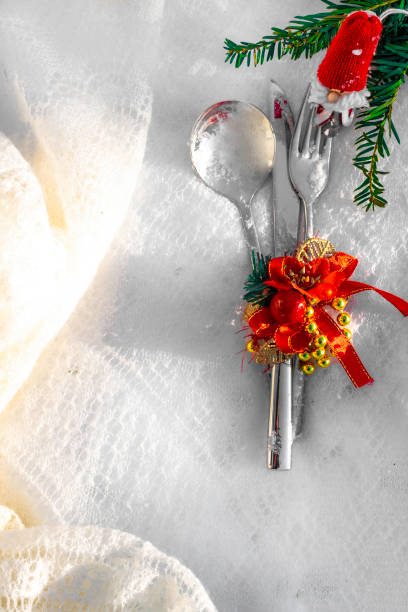 istock Festive table setting for christmas or new year dinner: vintage fork, spoon,knife and xmas decorations on white background with copy space 1074875080