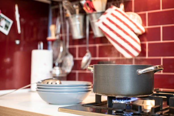 istock cooking pot on gas stove with blue dishes ready on the side 1074875728