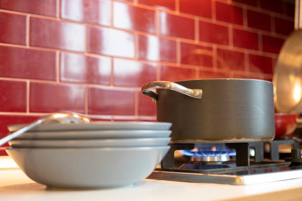 istock cooking pot on gas stove with blue dishes ready on the side 1074875820