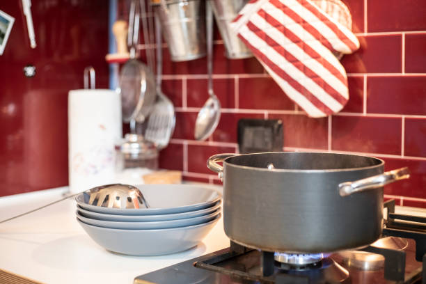 istock cooking pot on gas stove with blue dishes ready on the side 1074875878