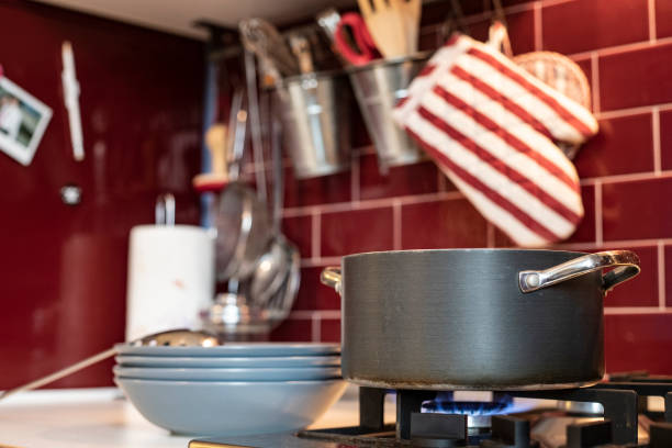 istock cooking pot on gas stove with blue dishes ready on the side 1074876004