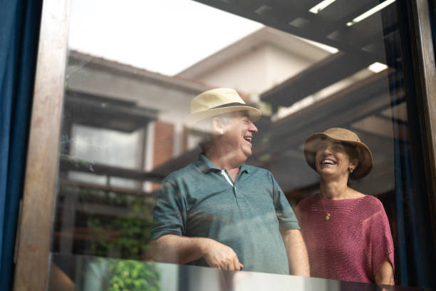istock Senior Couple Looking Through Window - Portrait 1074878784