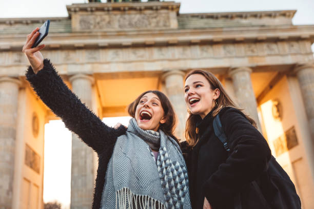 istock Two Friends at Brandeburg Gate in Berlin take a selfie 1074881210