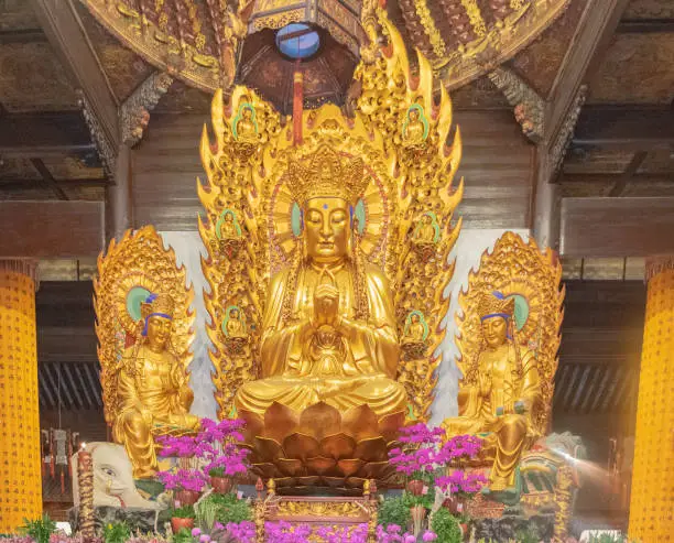 Photo of Guanyin.Gold statues of the Lohans in Longhua buddhist temple, Shanghai, China.