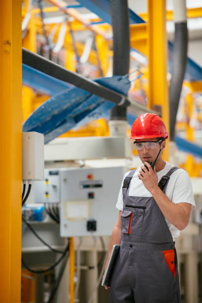 istock Handsome factory worker with walkie-talkie 1074884024