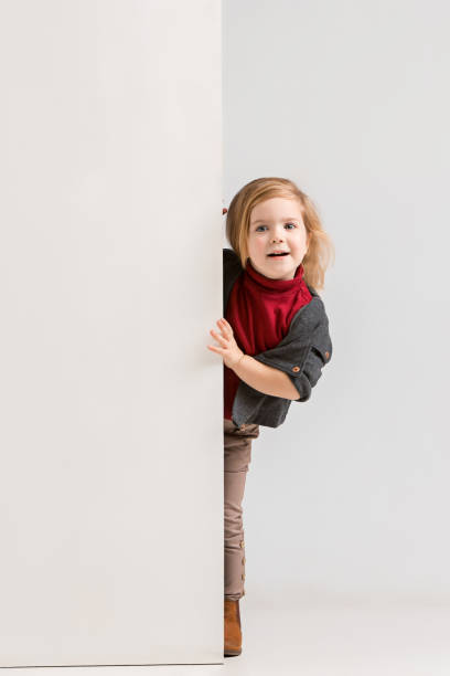 istock Banner with a surprised child peeking at the edge 1074884302