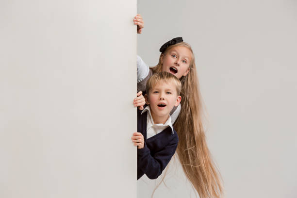 istock Banner with a surprised children peeking at the edge 1074884304