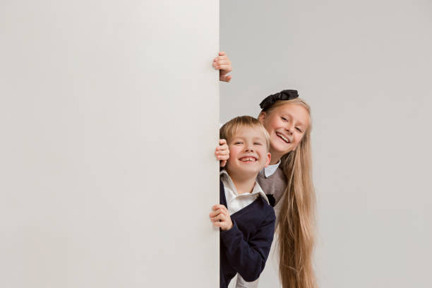 istock Banner with a surprised children peeking at the edge 1074884314