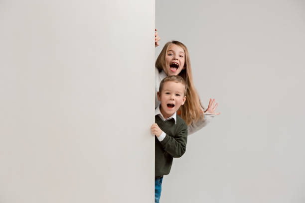 istock Banner with a surprised children peeking at the edge 1074884320