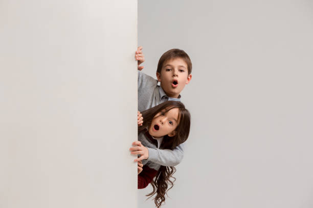 istock Banner with a surprised children peeking at the edge 1074884328