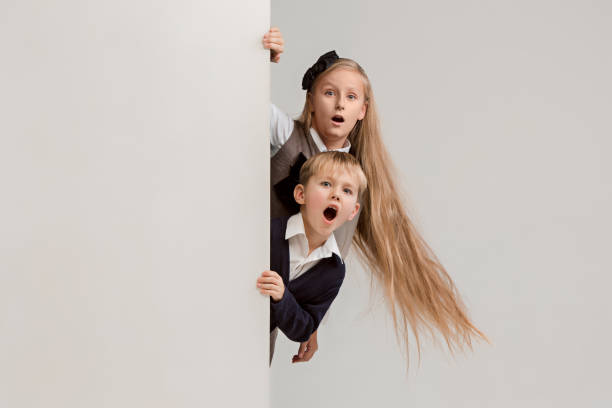 istock Banner with a surprised children peeking at the edge 1074884332