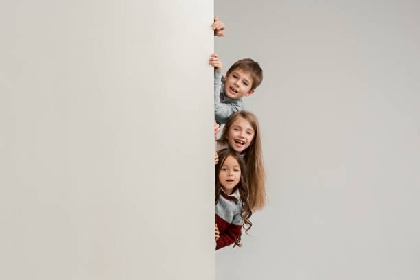 istock Banner with a surprised children peeking at the edge 1074884344