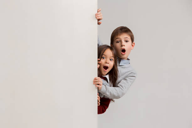 istock Banner with a surprised children peeking at the edge 1074884358