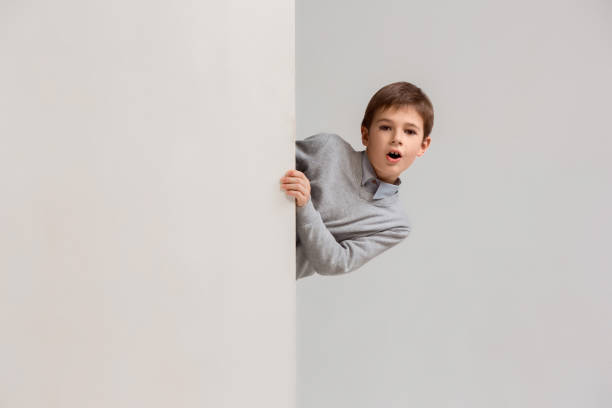 istock Banner with a surprised child peeking at the edge 1074884360