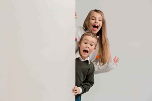 istock Banner with a surprised children peeking at the edge 1074884370