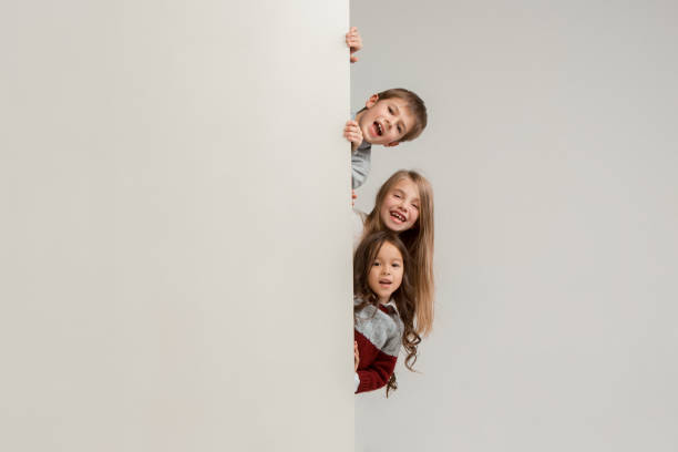 istock Banner with a surprised children peeking at the edge 1074884382