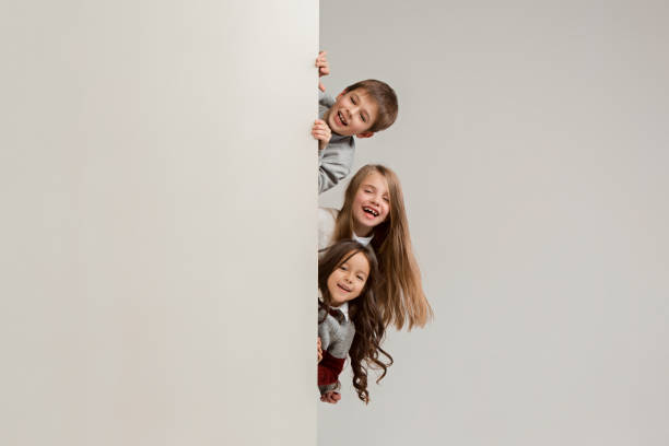 istock Banner with a surprised children peeking at the edge 1074884394