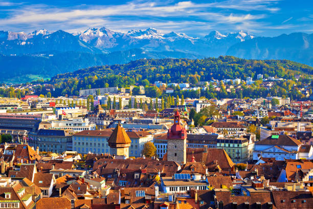 istock Idyllic Luzern rooftops and Apline peaks background view, central Switzerland 1074885050