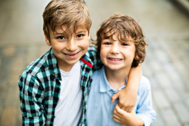 istock cute children, brothers, in a parkhaving fun 1074886914