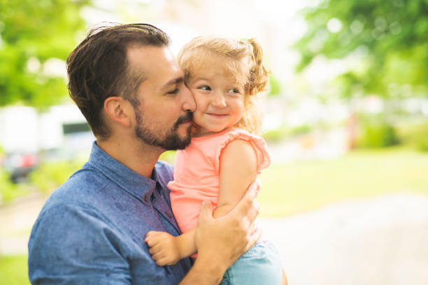 istock Father and Daughter in a park on summer day 1074886952